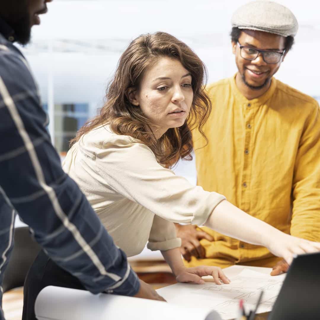 woman in a hard hat and safety vest working on a machine